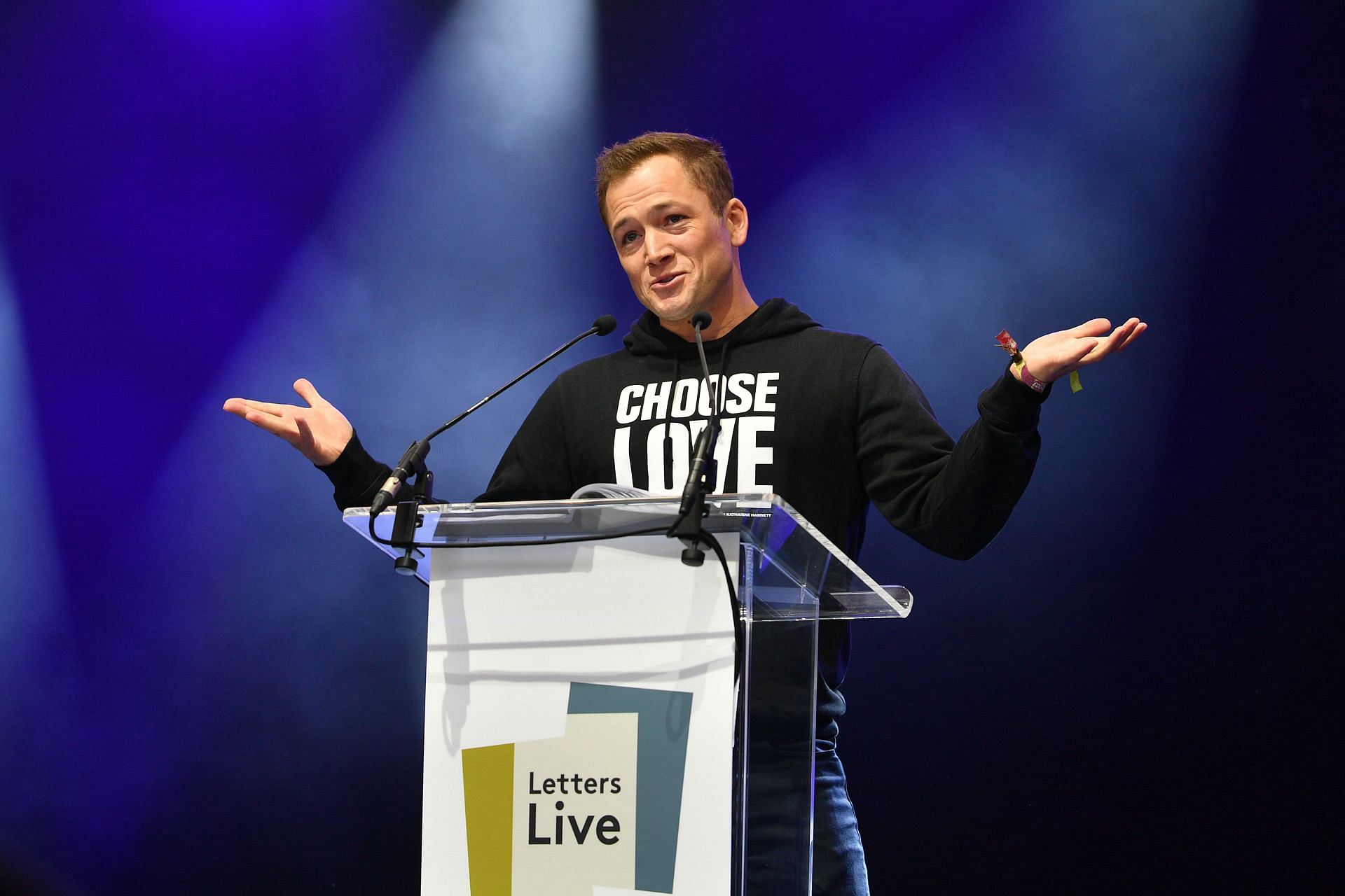 Actor Taron Egerton reads during a performance of 'Letters Live' during the 2023 Wilderness Festival at Cornbury Park on August 05, 2023 in Charlbury, Oxfordshire. (Image via Getty)
